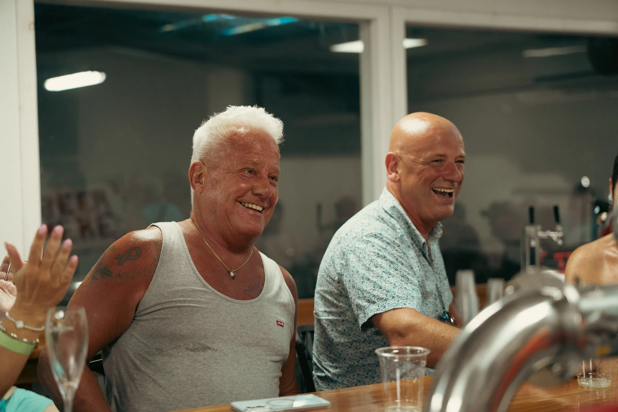 Two guests laughing during a tasting at the brewery