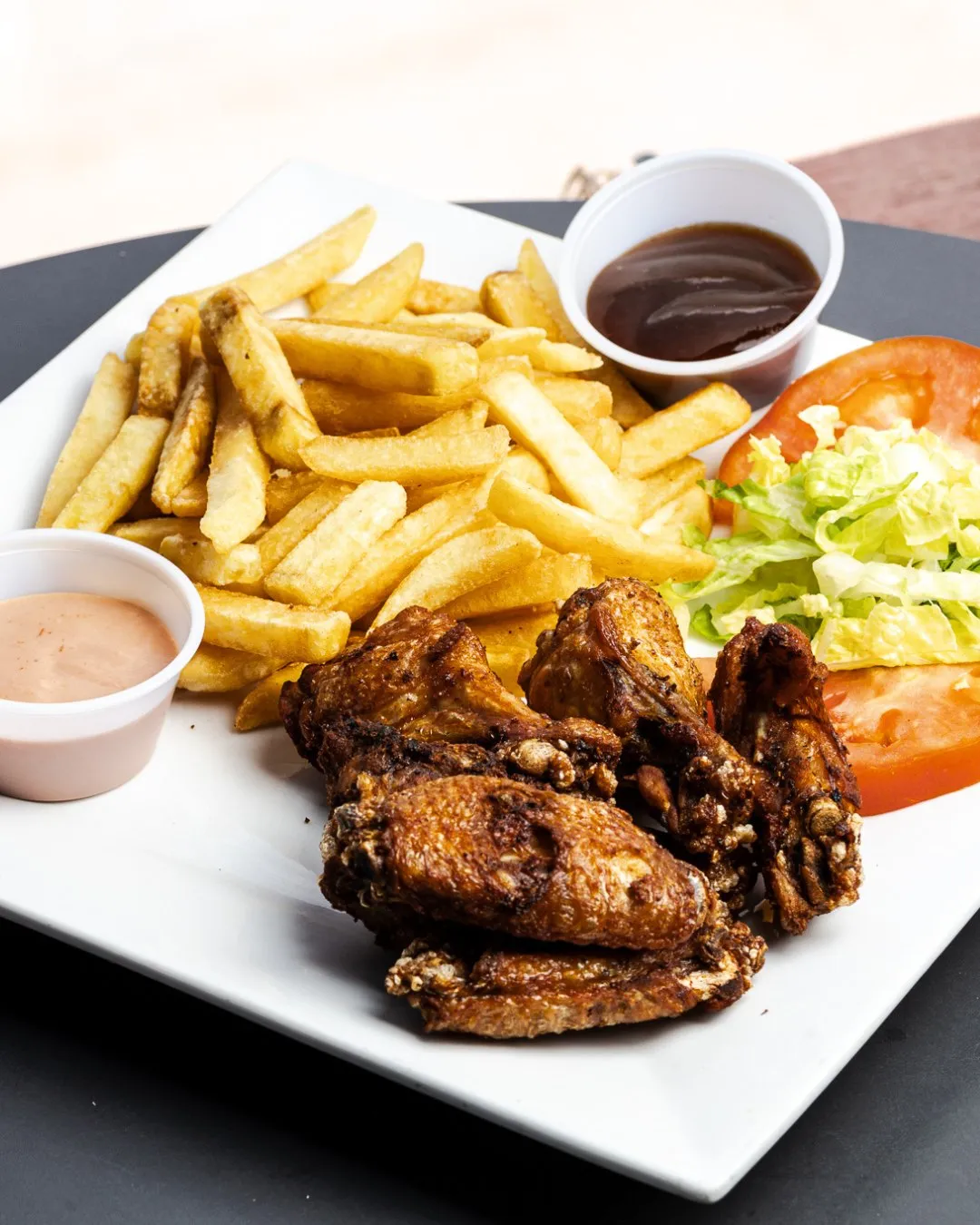 Chicken wings with fries and dipping sauce